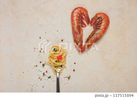 spaghetti wrapped on a fork, langoustines heart shape, on the table, food concept , food background, top view, 117515894