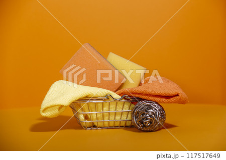 Small metal basket from hardware store on orange background Small metal basket from hardware store on orange background 117517649