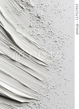 White paint smeared on a clean surface with a cap beside it 117517915