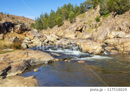A tranquil stream flowing through the countryside in the Snowy Mountains 117518029
