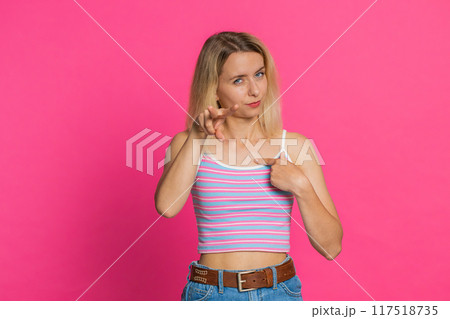 Young woman pointing at eyes and camera show I am watching you gesture spying, watching on someone 117518735
