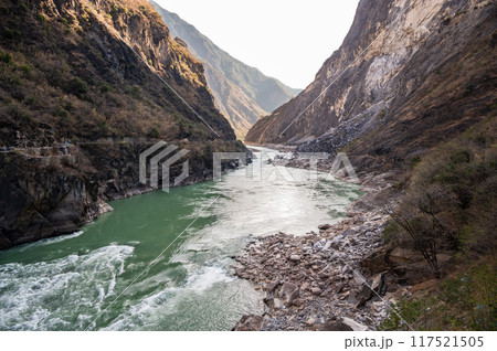 The landscape of Tiger Leaping Gorge in Yunnan province of China. Scenic spot where a tiger is said to have leaped across the river, thus giving the gorge its name. The landscape of Tiger Leaping Gorge in Yunnan province of China. Scenic spot where a tiger is said to have leaped across the river, thus giving the gorge its name. 117521505