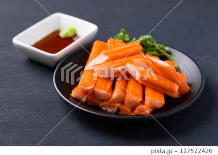 Crab sticks on black plate eating with wasabi and sauce Crab sticks on black plate eating with wasabi and sauce 117522426