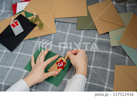Step by step instruction of making handmade Christmas advent calendar with envelopes. Creative craft homemade decor. New year celebration. Winter Step by step instruction of making handmade Christmas advent calendar with envelopes. Creative craft homemade decor. New year celebration. Winter 117522438