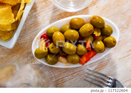 Assorted green olives and vegetables served in bowl Assorted green olives and vegetables served in bowl 117522604