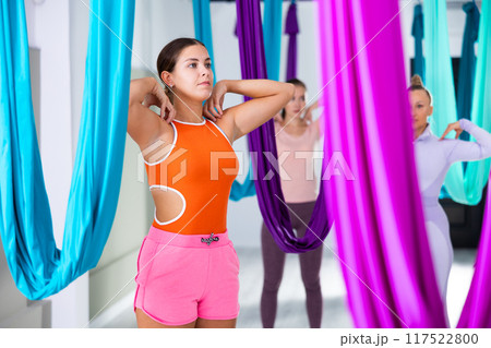 Warm up muscles before yoga class of women Warm up muscles before yoga class of women 117522800