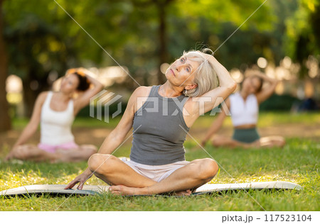 Elderly woman doing yoga in lotus position Elderly woman doing yoga in lotus position 117523104