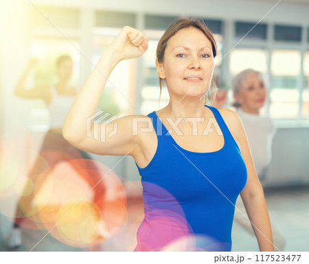 Adult woman doing fitness in fitness studio 117523477