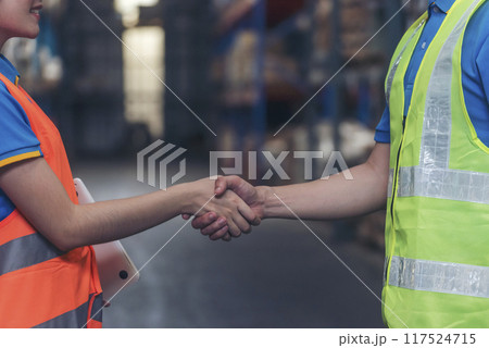 Close up warehouse worker shakehand together. Engineer man hands partnership. Diversity Coworker Men logistics Warehouse teams handshake. Multiracial Support team greeting person teamwork colleagues 117524715