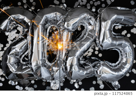 Happy new year 2025 metallic balloons with confetti and sparkler firework Bengal lights on dark black background. Greeting card silver foil balloons numbers Christmas holiday concept. Celebration Happy new year 2025 metallic balloons with confetti and sparkler firework Bengal lights on dark black background. Greeting card silver foil balloons numbers Christmas holiday concept. Celebration 117524865