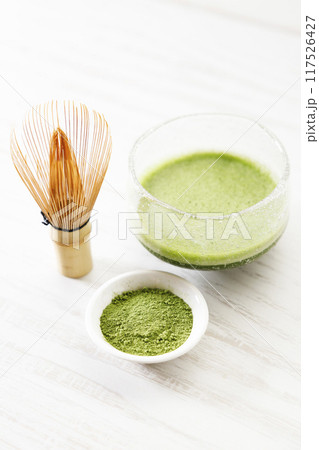 Cup of fresh matcha, green tea, and bamboo whisk. Cup of fresh matcha, green tea, and bamboo whisk. 117526427
