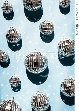Shiny mirrored disco balls casting reflections and creating festive atmosphere. Shiny mirrored disco balls casting reflections and creating festive atmosphere. 117528384