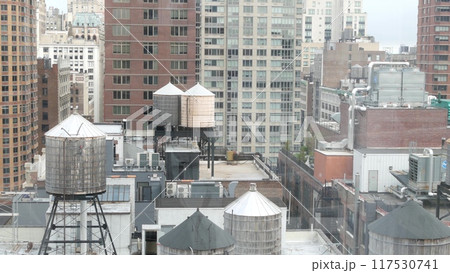 New York City Manhattan cityscape. Rooftop water towers, residential district buildings roof tanks. 117530741