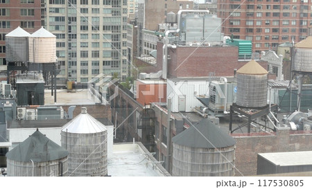 New York City Manhattan cityscape. Rooftop water towers, residential district buildings roof tanks. 117530805