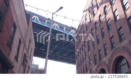 New York City Manhattan Bridge in Dumbo. Industrial red brick building, Plymouth street in Brooklyn. 117530845