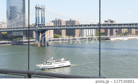 New York City Manhattan Bridge from Brooklyn Bridge. USA NYC skyline cityscape. East River water. New York City Manhattan Bridge from Brooklyn Bridge. USA NYC skyline cityscape. East River water. 117530881