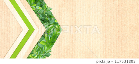 Green leaves and arrow symbol on recycled cardboard texture . Horizontal banner with eco paper texture. Paper background. Recycled carton material. Ecology and zero waste concept. Copy space for text 117531805