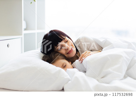 Mother and child sleeping peacefully in white bed Mother and child sleeping peacefully in white bed 117532698