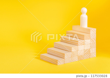Businessman climbing stairs. Business success process, career ladder. Wooden figurine Businessman climbing stairs. Business success process, career ladder. Wooden figurine 117533028