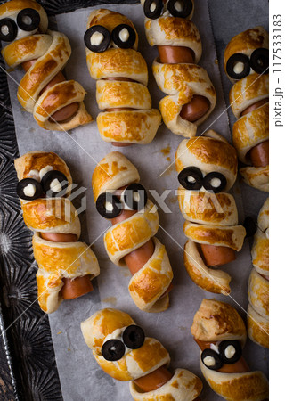 Halloween food. Ssausage in shape of mummies Halloween food. Ssausage in shape of mummies 117533183