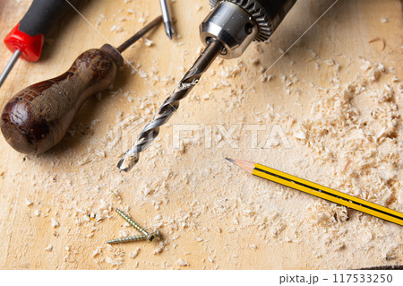 drill perched on a wooden board 117533250