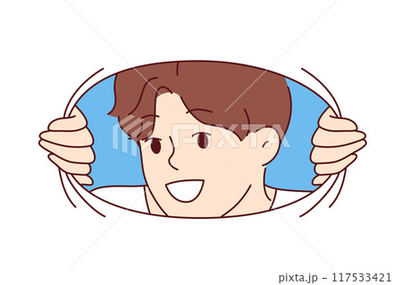 Smiling man looks at screen through hole in material, sharing positivity and good mood with you 117533421