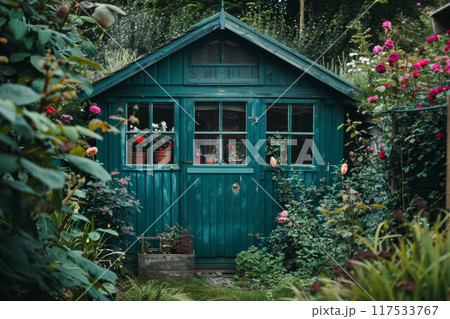 English back garden with shed amongst the plants 117533767