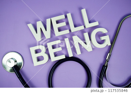 Well Being alphabet letters and stethoscope on purple background, Healthcare concept 117535846