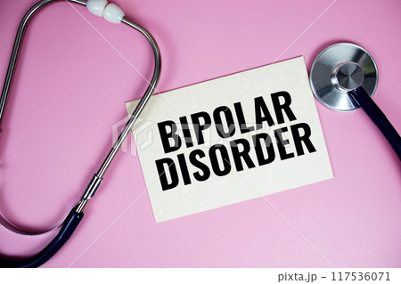 Bipolar Disorder text with stethoscope top view on pink background, Healthy and wellness conceptpt 117536071