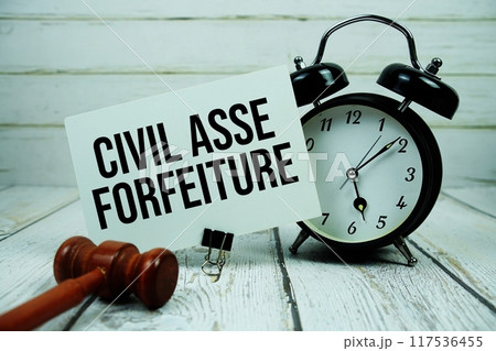 Civil Asset Forfeiture text on paper card with alarm clock and wooden judge gavel on wooden background 117536455
