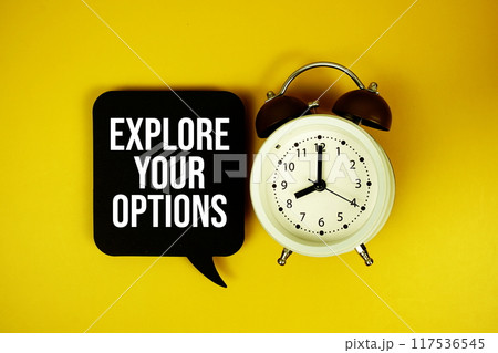 Explore Your Options text on speech bubble with alarm clock top view on yellow background 117536545
