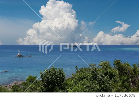 Blue sea with boats floating on the surface on a clear day. 117536679