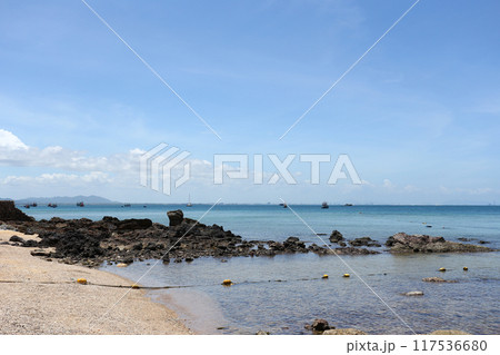 Coastal rocks after low tide against a blue sky at Samae San Bay. Coastal rocks after low tide against a blue sky at Samae San Bay. 117536680