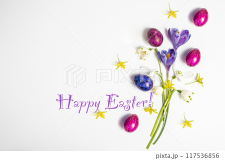 Text Happy Easter. Colorful easter eggs and flowers crocus isolated on 117536856