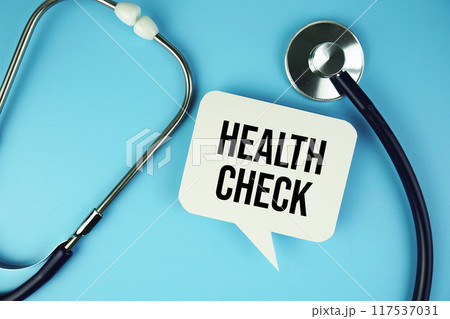 Health Check text on speech bubble with stethoscope top view on blue background Health Check text on speech bubble with stethoscope top view on blue background 117537031