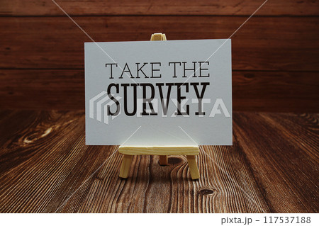 Take The Survey text on paper card on wooden background Take The Survey text on paper card on wooden background 117537188