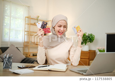 A woman is holding several credit cards and smiling A woman is holding several credit cards and smiling 117538805