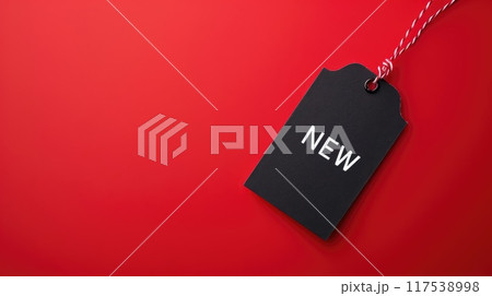 black paper label with new text on clean red background 117538998