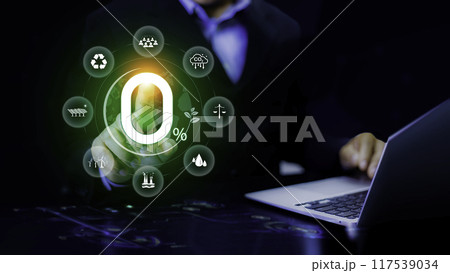 Net zero 2050 concept. Businessman point at zero icon Green energy icon around it. Green Energy Renewable Sustainable. Net zero emission Idea innovative. carbon neutrality in industry. 117539034