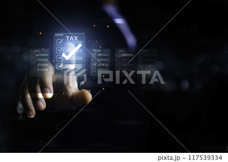 income tax. Businessman pointing to tax icon. income tax system icon around. pay online income tax. futuristic virtual screen interface technology.Money saving ideas in the age of virtual technology.. 117539334