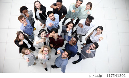 multicultural successful business group looking up in office corridor 117541201