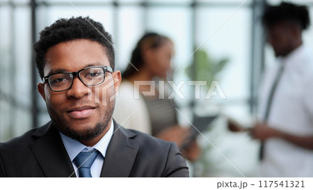 Attractive guy with a charming smile and glasses 117541321