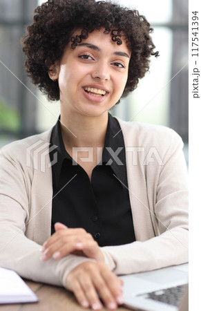 Portrait of Young Successful Caucasian Businesswoman Sitting at Desk Working on Laptop 117541394