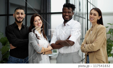 Happy multiethnic professional business team standing together in office hallway Happy multiethnic professional business team standing together in office hallway 117541832
