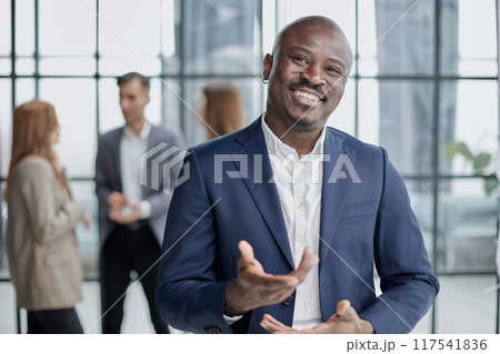 Handsome african american executive businessman in modern office 117541836