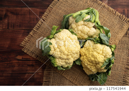 Whole Fresh cauliflower heads on dark wooden background.Top view.with copy space 117541944