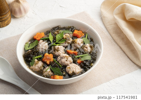 Thai style Clear seaweed soup with carrot ,Minced Pork ball and glass noodle in white bowl.(Gaeng Jued ) Thai style Clear seaweed soup with carrot ,Minced Pork ball and glass noodle in white bowl.(Gaeng Jued ) 117541981