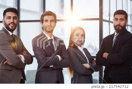 Portrait of four office workersr arms over their chest. 117542712