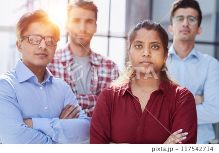 Theyre all about their business. Shot of a group of businesspeople standing in an office at work. Theyre all about their business. Shot of a group of businesspeople standing in an office at work. 117542714