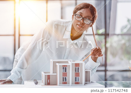 woman architect designer examines the layout of the house. new project 117542748